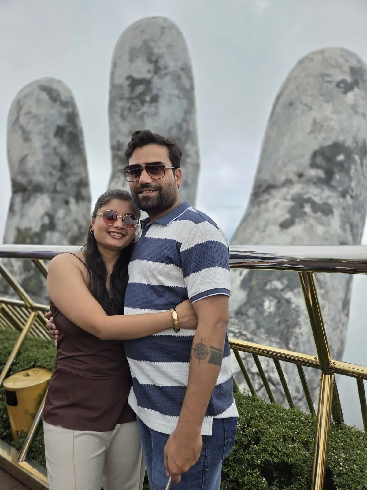 Up close, the hands are weathered concrete made to look like old stone — guests on one of our Da Nang day trips