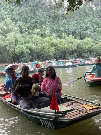 Bliss Tourism guests on tour — Rowing through Trang An, Ninh Binh, Vietnam